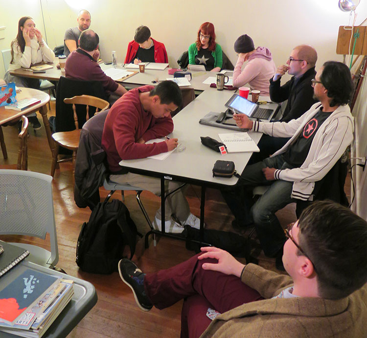 Photo of a Cloudscape meeting. Artists drawing together.